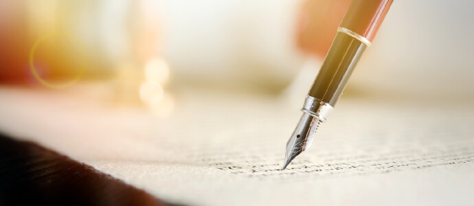 Notary signs legal contract. Close up of fountain pen on paper