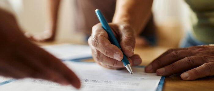 People sign documents