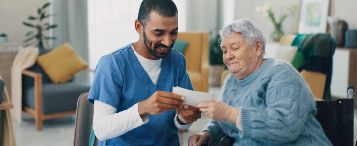 Elderly, photo album or caregiver with old woman in retirement talking or bonding together in nursing home. Love, memory or senior women with pictures for support or care with a happy nurse on break