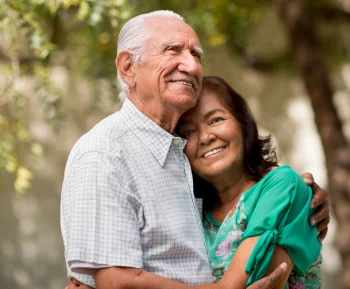 a husband and wife smiling together