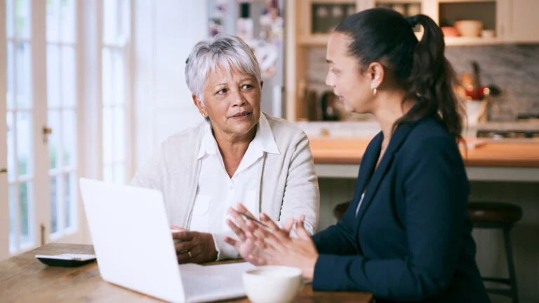 Older woman sitting with estate planning attorney