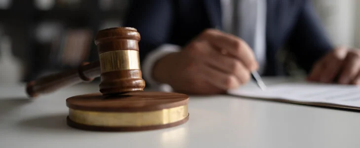 Judge or Legal advisor lawyer examining and signing legal documents.