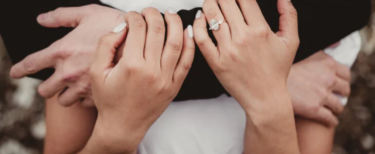 Engaged couple embracing close up